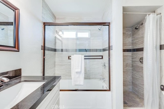 bathroom featuring vanity and shower / bath combination with glass door