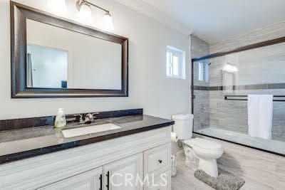 full bathroom featuring shower / bath combination with glass door, vanity, and toilet