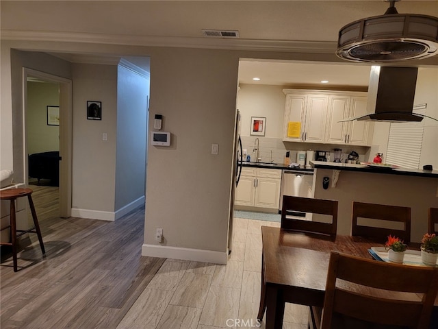 kitchen with sink, light hardwood / wood-style flooring, stainless steel appliances, white cabinets, and island exhaust hood