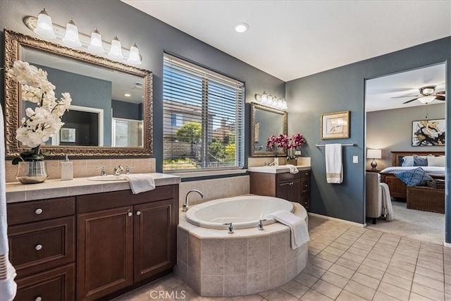 bathroom with vanity, ceiling fan, tiled tub, and tile patterned flooring