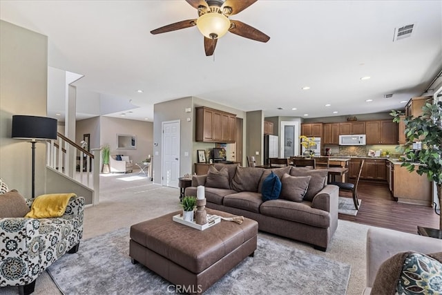 living room featuring ceiling fan and light hardwood / wood-style floors