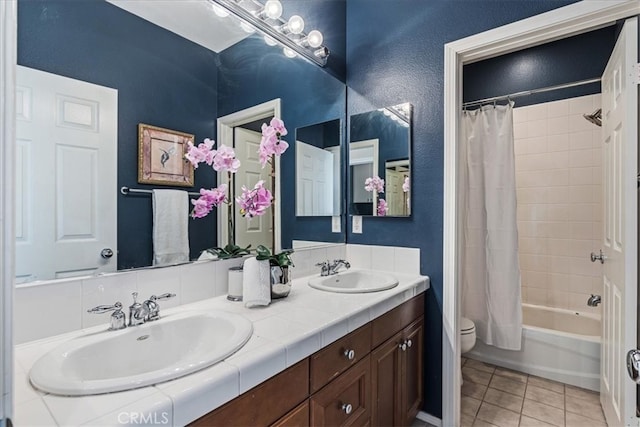 full bathroom featuring toilet, shower / tub combo with curtain, vanity, and tile patterned floors