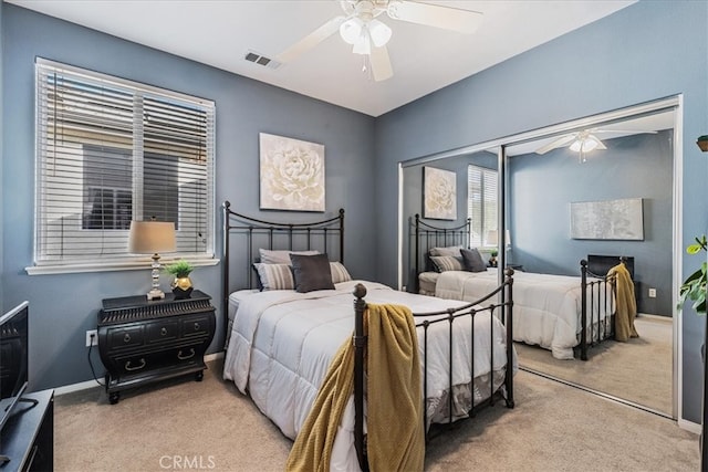 carpeted bedroom with a closet and ceiling fan