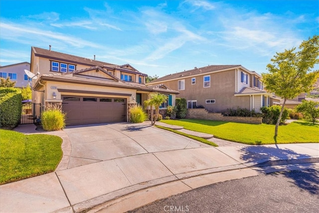 view of front of home featuring a garage and a front lawn