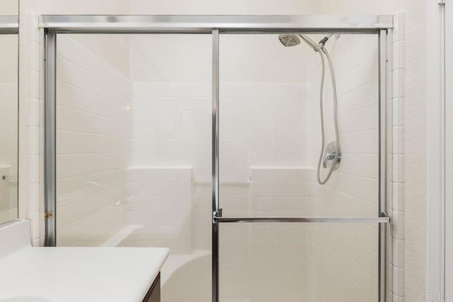 bathroom with an enclosed shower and vanity