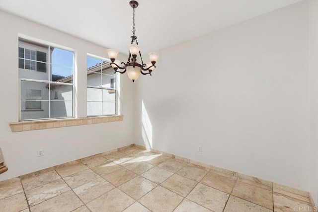 unfurnished dining area featuring an inviting chandelier