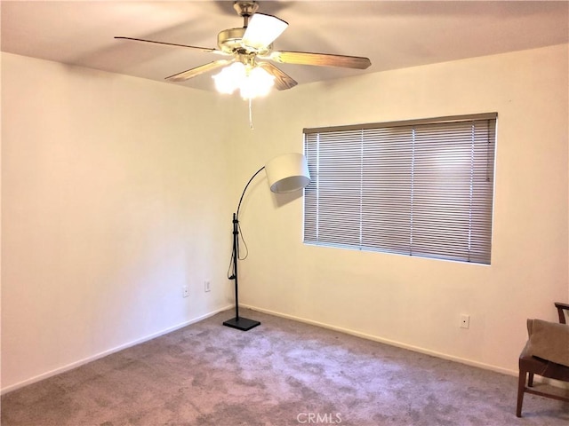 unfurnished room featuring a ceiling fan, carpet, and baseboards