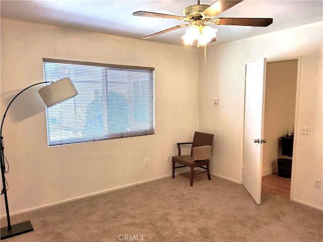 unfurnished room with light colored carpet, ceiling fan, and baseboards