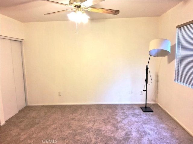 interior space with carpet and a ceiling fan