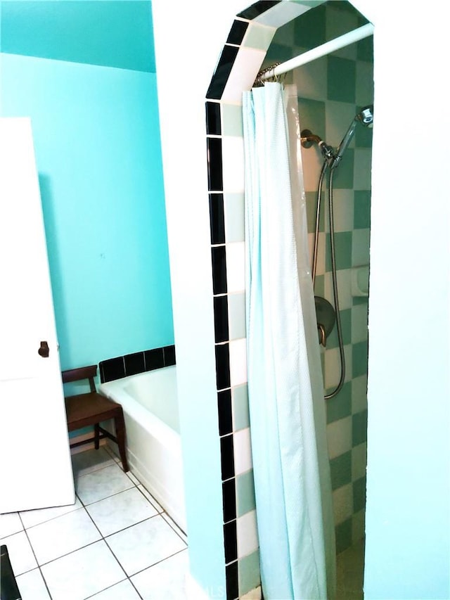 bathroom with tile patterned flooring and a shower stall