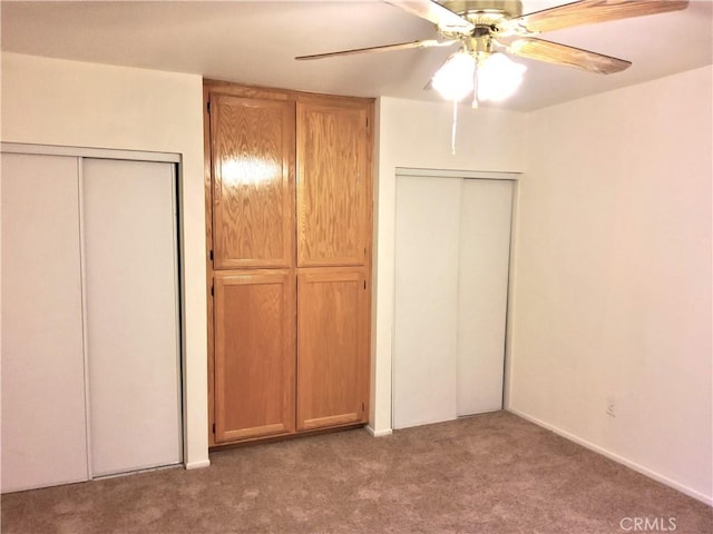 unfurnished bedroom featuring carpet floors and ceiling fan