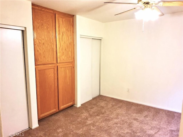 unfurnished bedroom with ceiling fan and carpet flooring