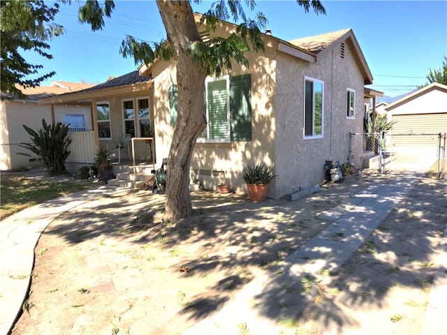 view of front of property featuring fence and stucco siding