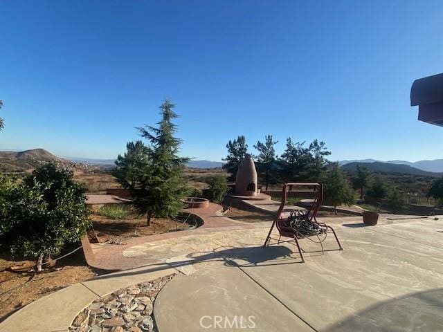 view of patio / terrace featuring a mountain view