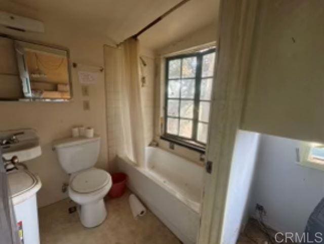 bathroom featuring shower / bath combo, a wealth of natural light, and toilet