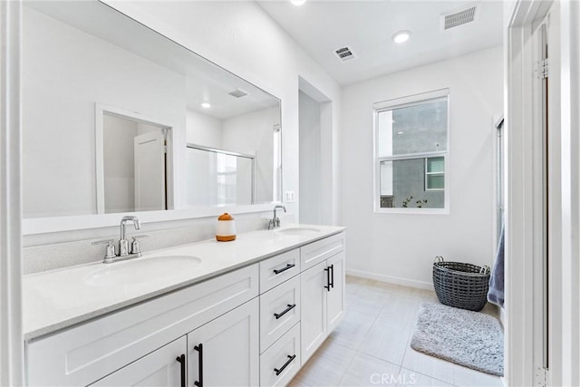 bathroom with tile patterned floors and vanity