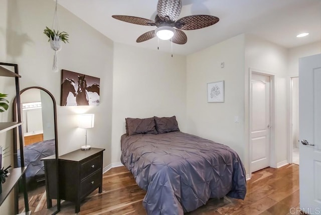 bedroom featuring connected bathroom, ceiling fan, and wood-type flooring