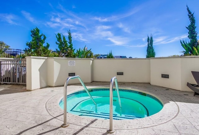 view of pool featuring a hot tub and a patio