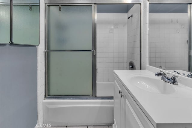 bathroom with vanity and shower / bath combination with glass door