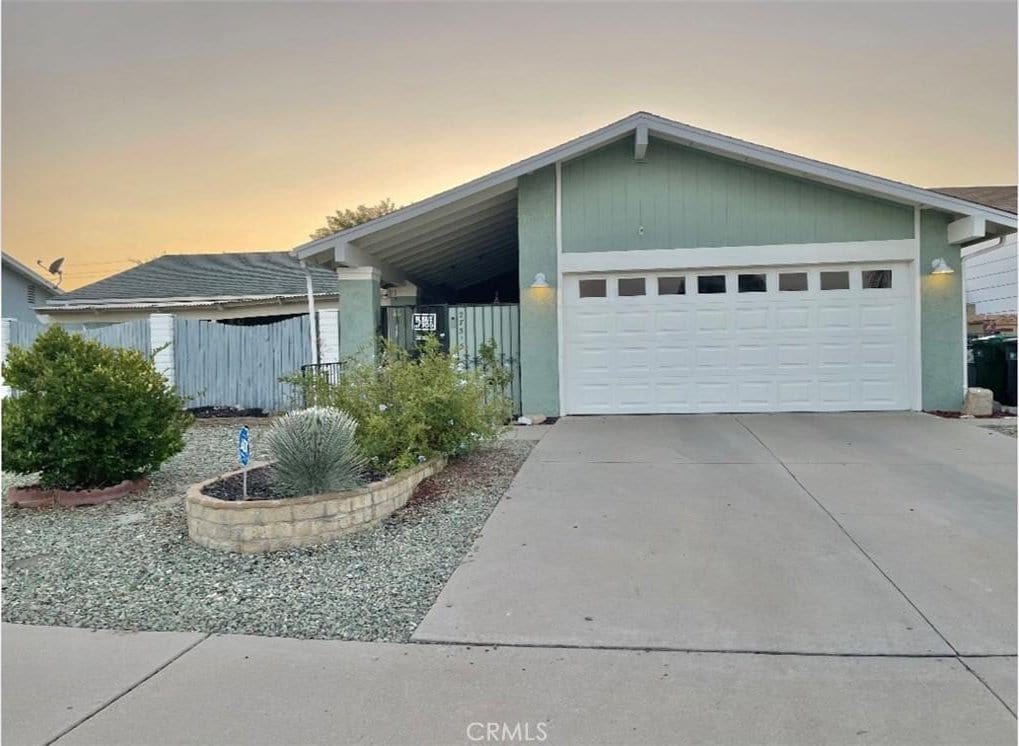 view of front of home featuring a garage and a carport