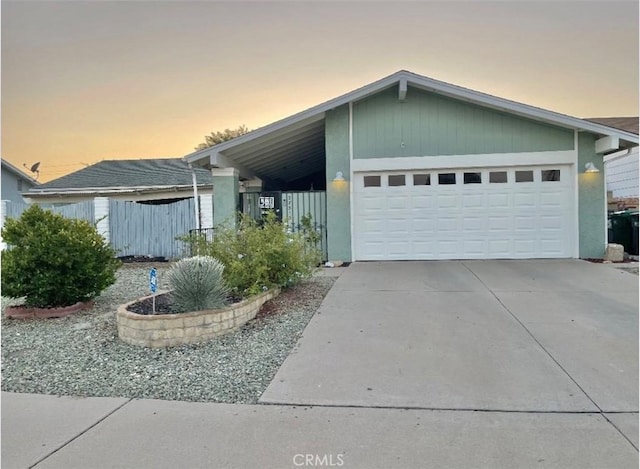 view of front of home featuring a garage and a carport