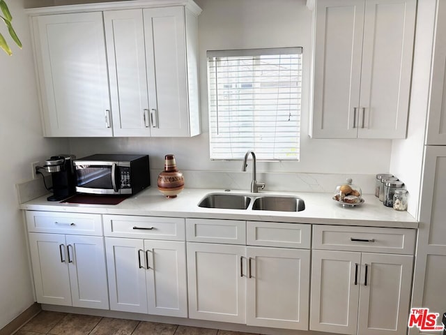 kitchen featuring sink and white cabinets