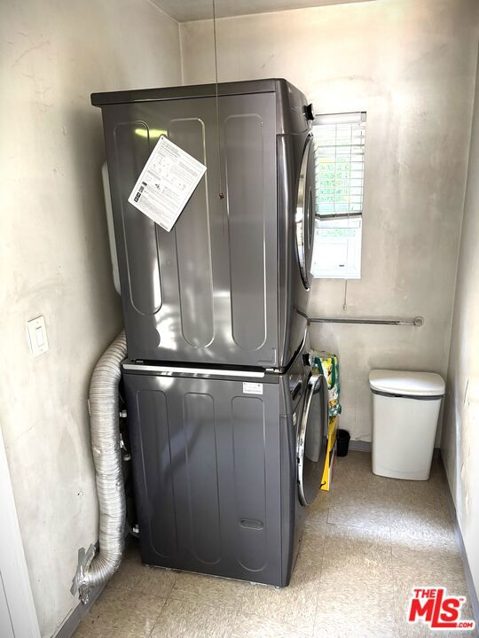 laundry area with stacked washer and clothes dryer