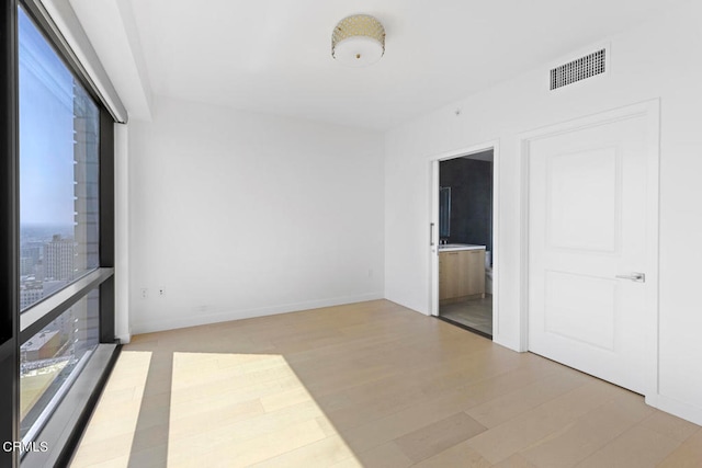 spare room with light wood-type flooring