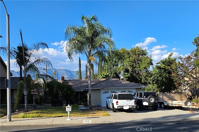 view of front of home featuring a mountain view and a garage