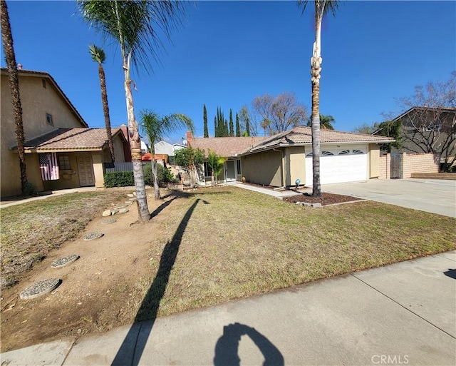 ranch-style home with a garage and a front lawn