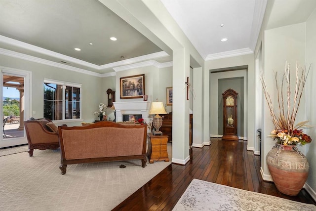 living room featuring dark hardwood / wood-style flooring and ornamental molding