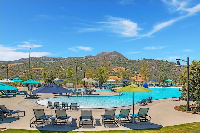 view of pool featuring a mountain view and a patio area