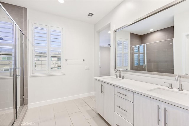 bathroom featuring vanity, tile patterned flooring, and a shower with door