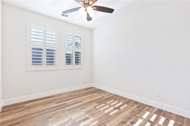 empty room with ceiling fan and light hardwood / wood-style floors