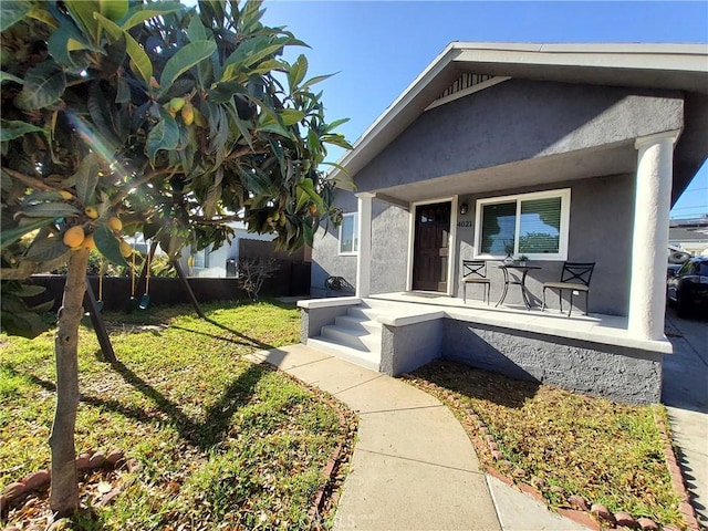 exterior space featuring a yard and covered porch