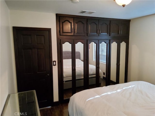 bedroom with dark hardwood / wood-style floors