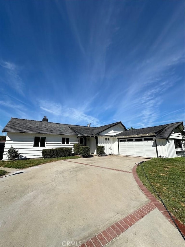 ranch-style house with a front lawn and a garage