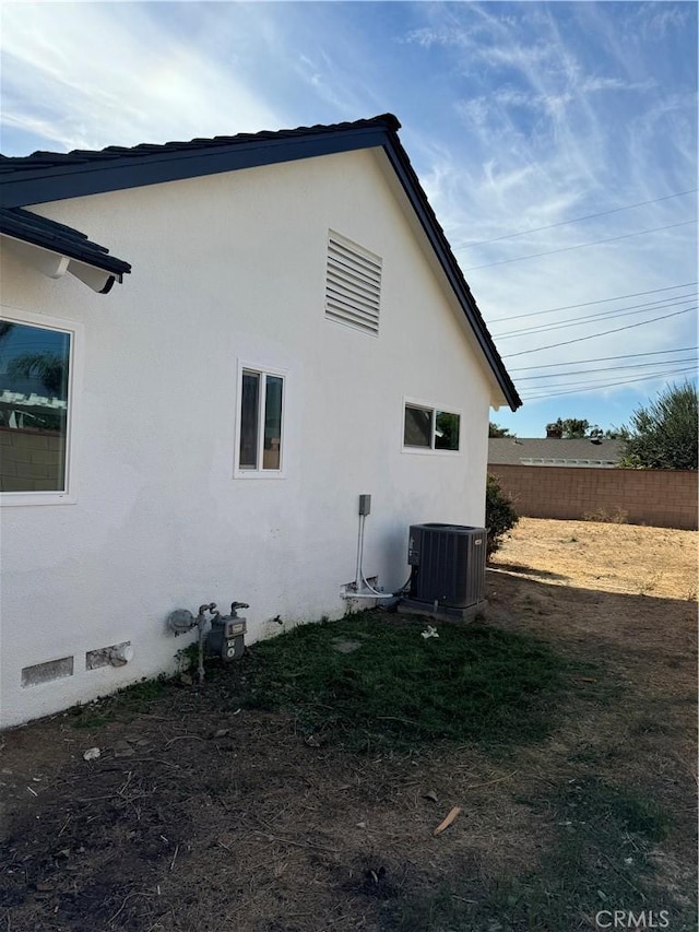 view of side of home featuring central AC