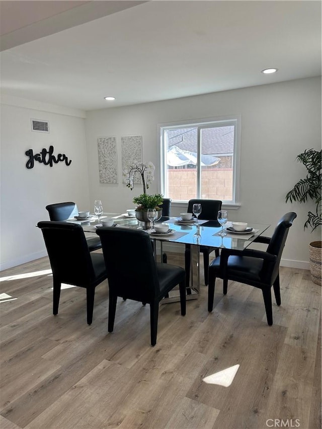 dining space featuring light wood-type flooring