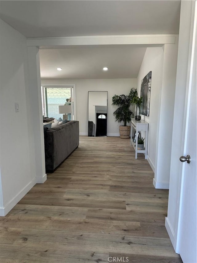 hallway with hardwood / wood-style floors and lofted ceiling