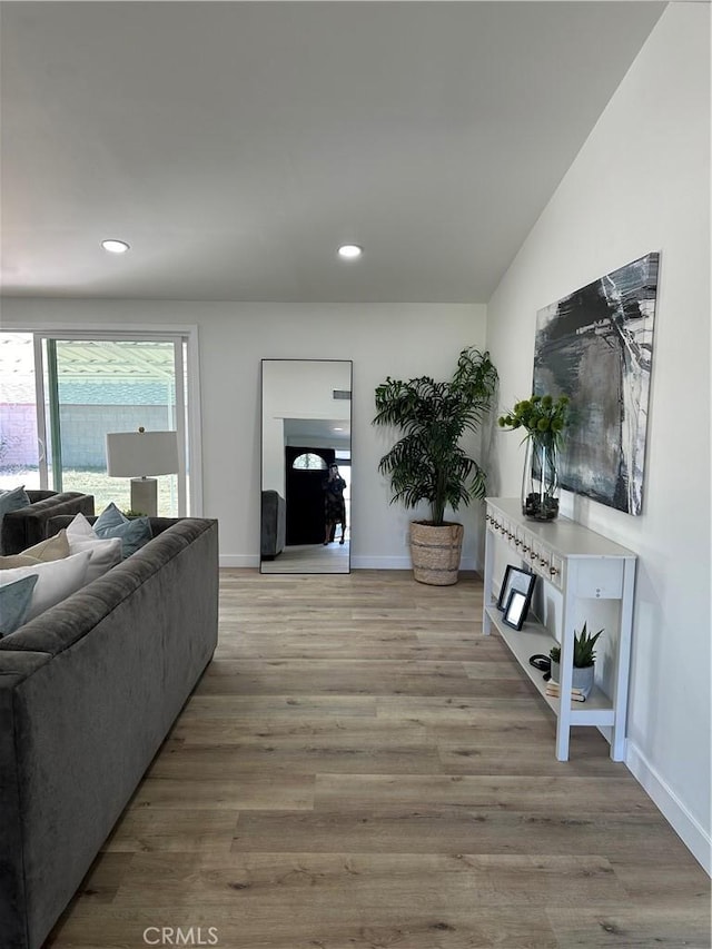 living room featuring light hardwood / wood-style floors and lofted ceiling