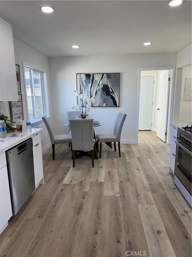 dining area featuring light wood-type flooring