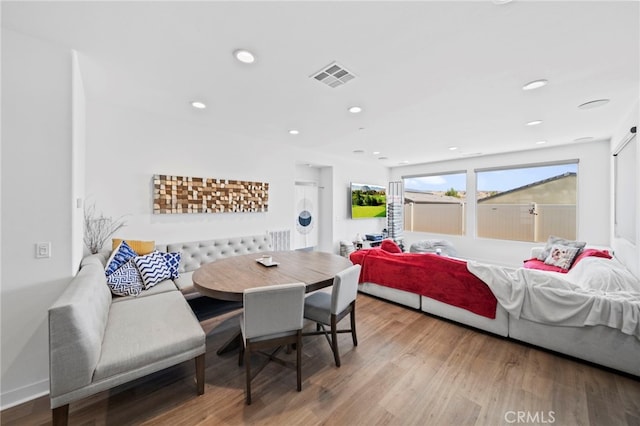 bedroom with hardwood / wood-style flooring and washer / clothes dryer