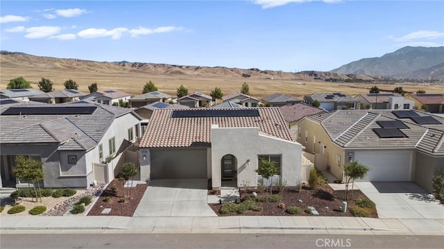 view of front of home with a mountain view and a garage