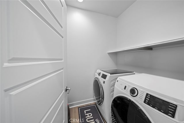 laundry room featuring dark wood-type flooring and washer and dryer