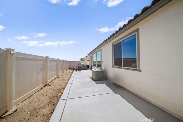 view of home's exterior with a patio area and central AC unit