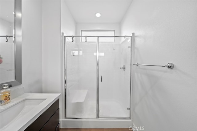 bathroom featuring vanity and an enclosed shower