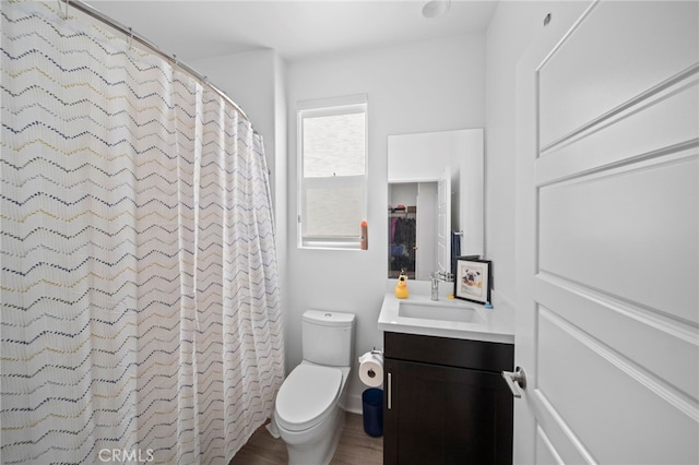 bathroom with vanity, toilet, and curtained shower