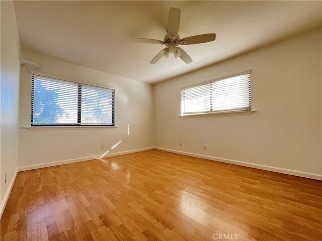 unfurnished room with ceiling fan and light wood-type flooring