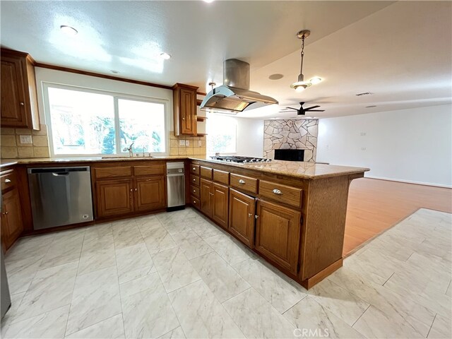 kitchen featuring appliances with stainless steel finishes, island exhaust hood, kitchen peninsula, ceiling fan, and decorative backsplash